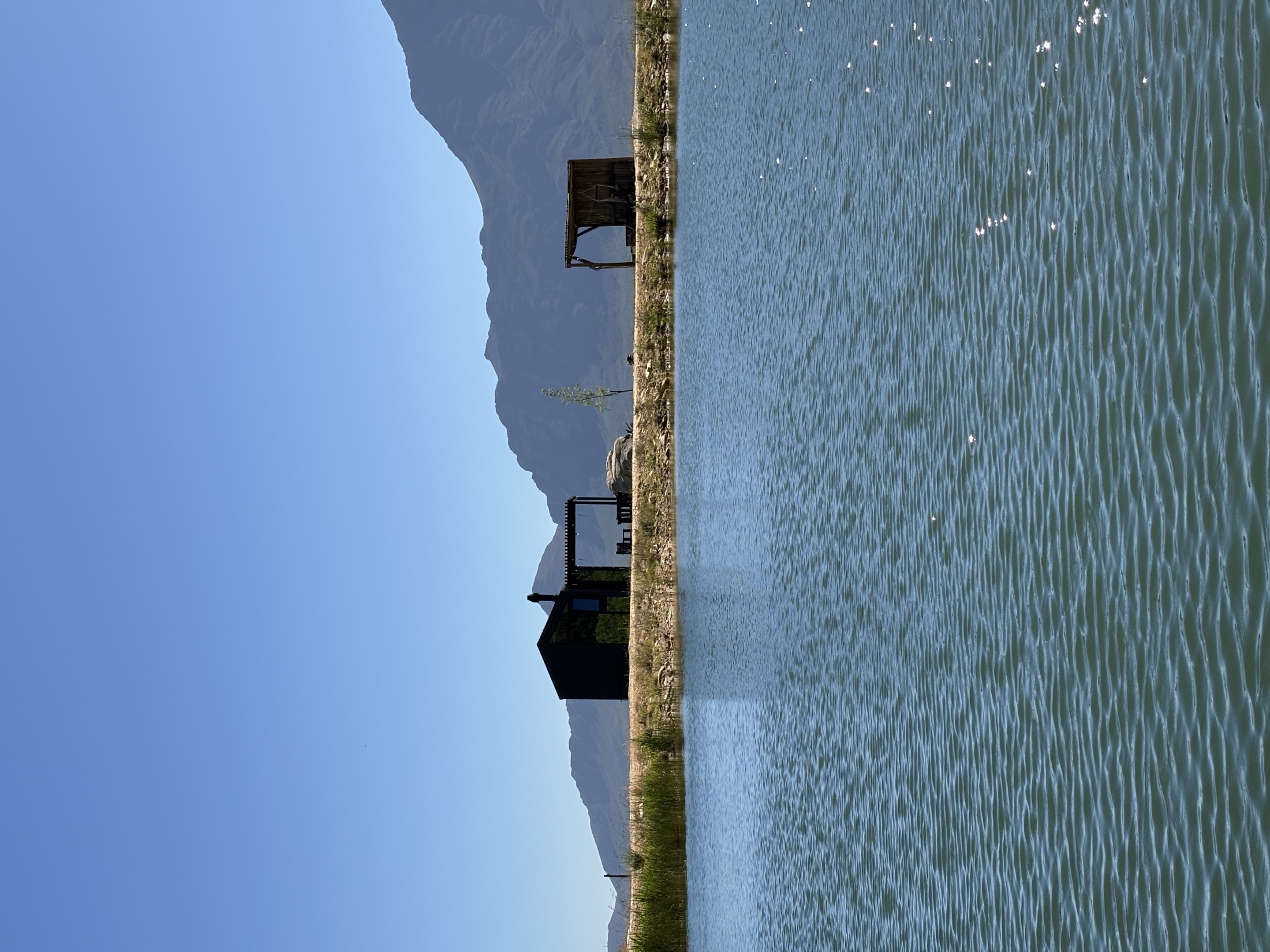 View over the tranquil farm dam towards the cabin